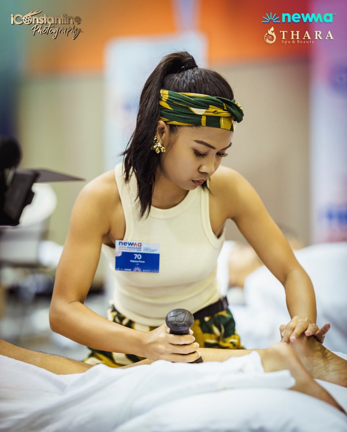 Massage therapist performing technique at Newma competition