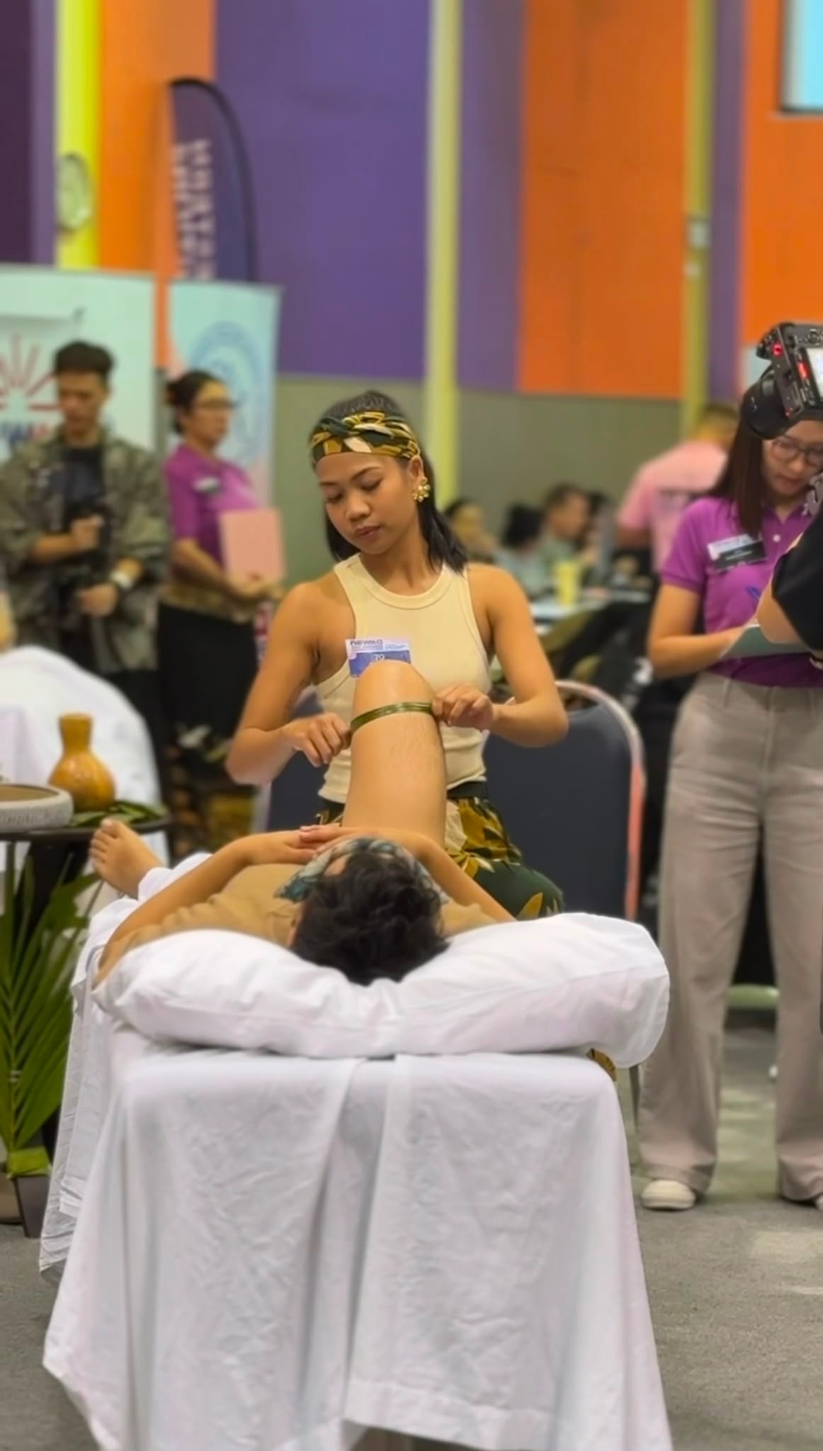 Massage competition floor with judges observing